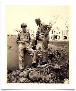 Amidst the rubble of Manila, Ed stands with Major John Boone, one of his commanders.  Both received the Distinguished Service Cross from MacArthur on June 13, 1945