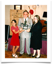 Emily & Amy Ramsey hold the bronze statue with Ed