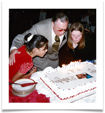 Emily & Amy Ramsey blowing candles with Ed