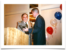 Mike Bills presenting a bronze cavalryman statue  Ed as a gift from Mike, Rich Cowell and Doug Morrison