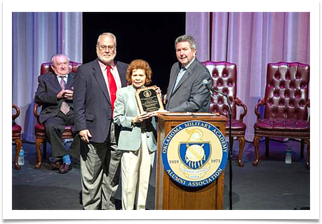 Raqui and Col. Edwin P. Ramsey Jr. receive the plaque establishing the Scholarship Endowment from Dr. Larry Rice, President, Rogers State University