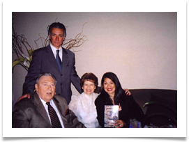 Jacqui Lingad-Ricci holding Ed's book with husband, John Ricci standing behind Ed & Raquel on May 28th, 2005 during reunion