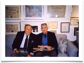 Col. Oliver North & Ed Ramsey reading radio message from Gen. Douglas MacArthur to Ramsey received Dec 1944