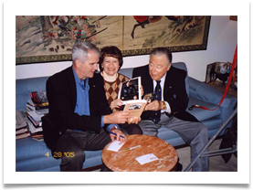 Ed presenting a copy of "Lt. Ramsey's War" to North with Raquel holding autographed photo from North to Ramsey