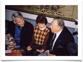 Col. North holding the copy of "Lt. Ramsey's War" presented to him by Ed with Raquel holding his photo