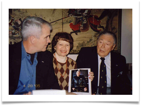 North presenting his photo to Ramsey, signed "To Ed Ramsey, A Real Hero! Semper Fidelis; Oliver North"